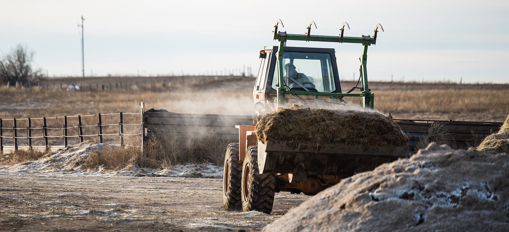 tractor carrying hay