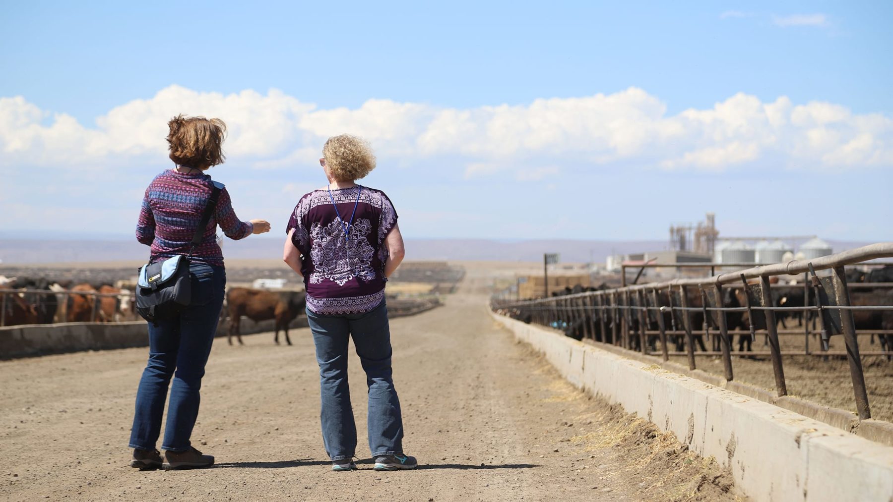 two woman talking on a ranch